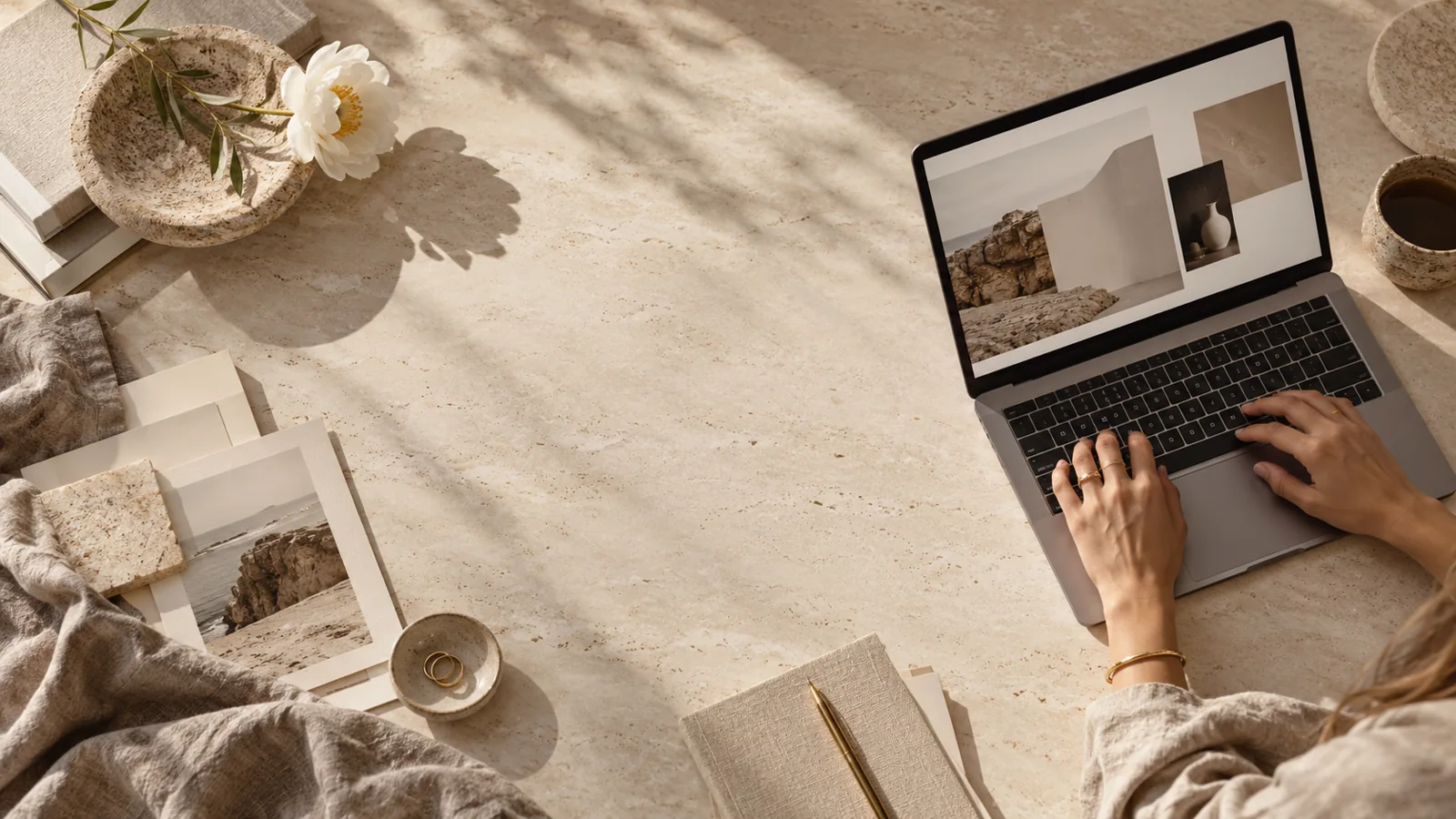 Laptop, notebook and design samples on a desk